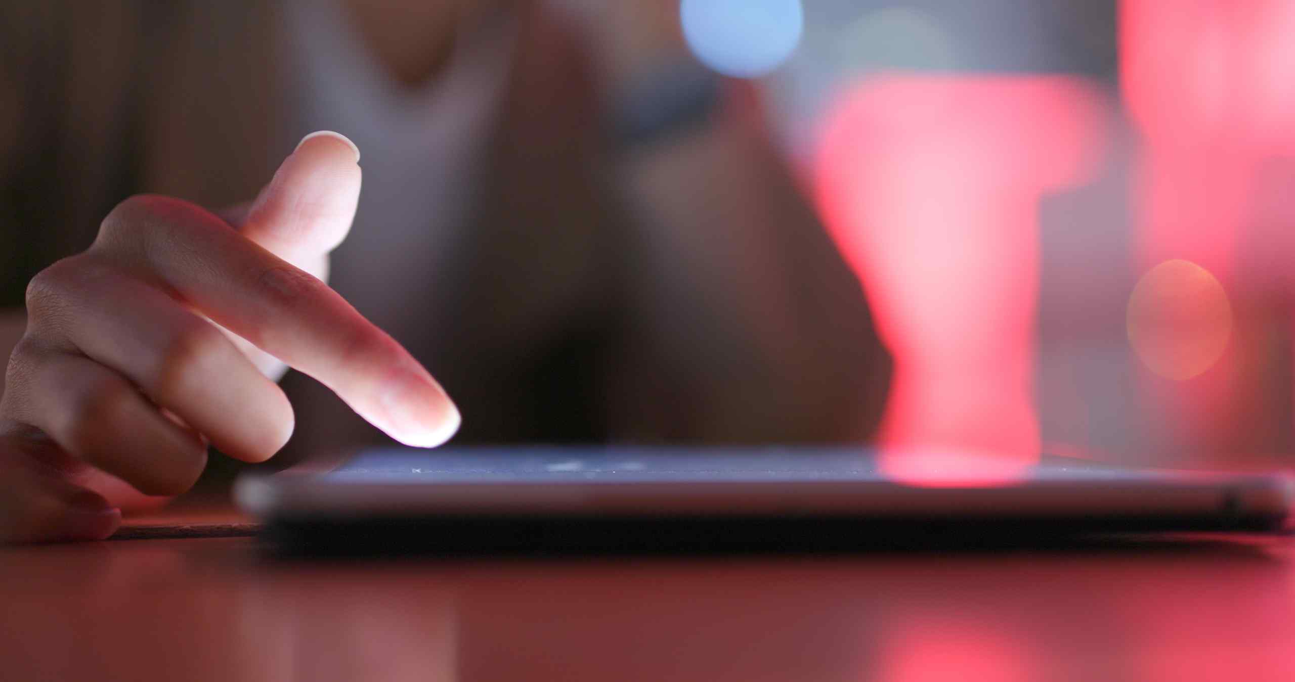 Someone using a smartphone on a table.